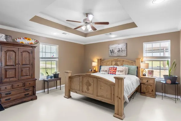 a bedroom with a bed and dresser with mirror