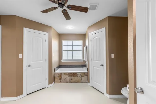 a spacious bathroom with a large mirror