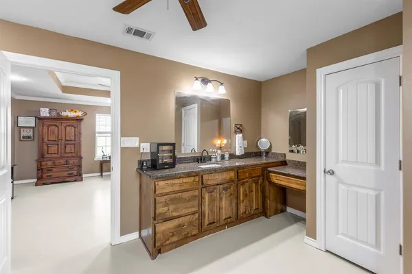 a large bathroom with a sink and a mirror
