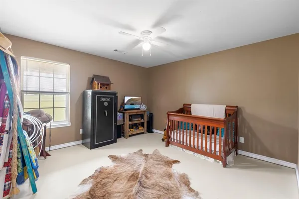 a bedroom with furniture and a window