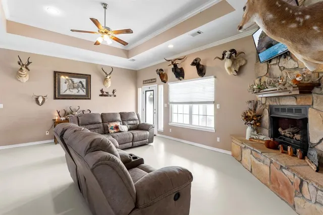 a living room with furniture a fireplace and a flat screen tv