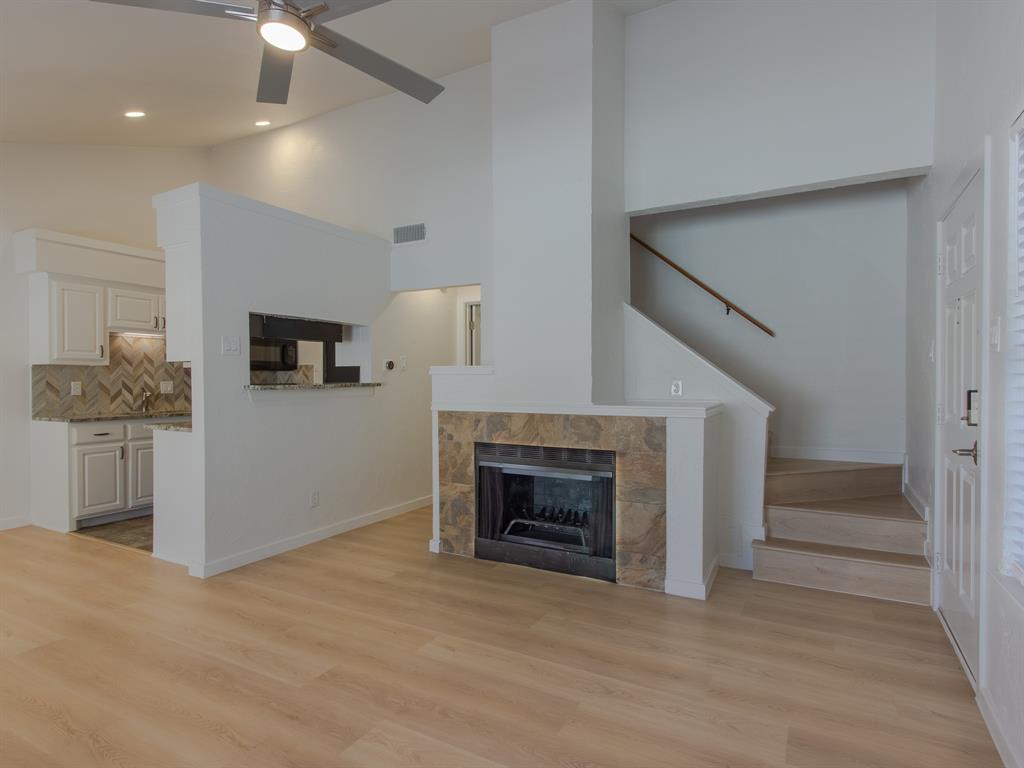 2240 Tarpley Road, Unit 62 Carrollton, TX 75006 - Photo 2 of 20 a view of a livingroom with an empty space and a fireplace