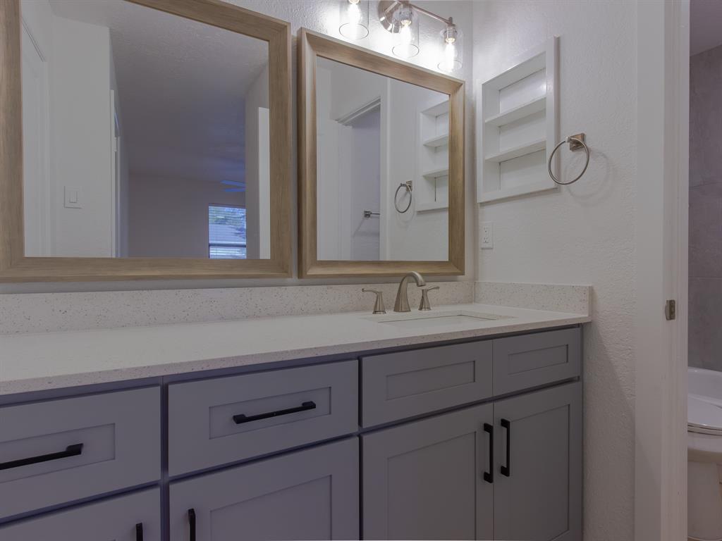2240 Tarpley Road, Unit 62 Carrollton, TX 75006 - Photo 5 of 20 a bathroom with a sink and mirror