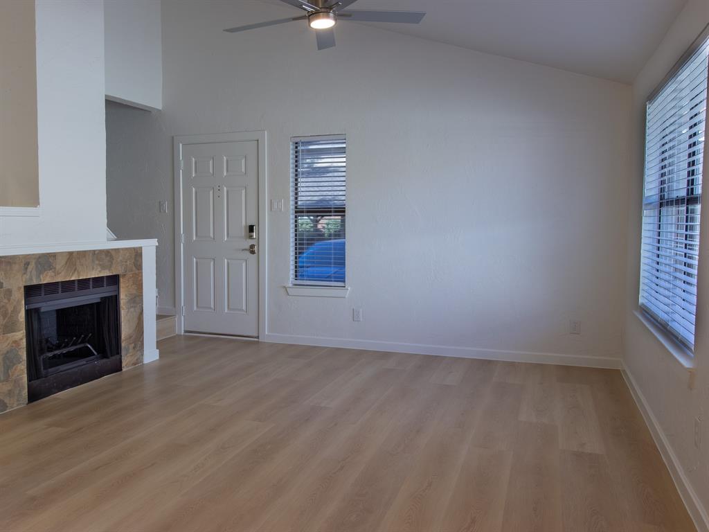 2240 Tarpley Road, Unit 62 Carrollton, TX 75006 - Photo 6 of 20 a view of an empty room with a fireplace and a window