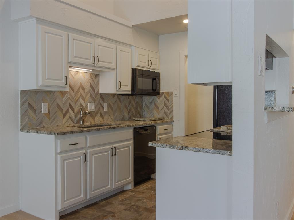 2240 Tarpley Road, Unit 62 Carrollton, TX 75006 - Photo 7 of 20 a kitchen with stainless steel appliances granite countertop a stove a microwave and a refrigerator