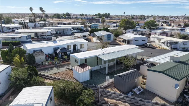 an aerial view of a house with a yard and lake view