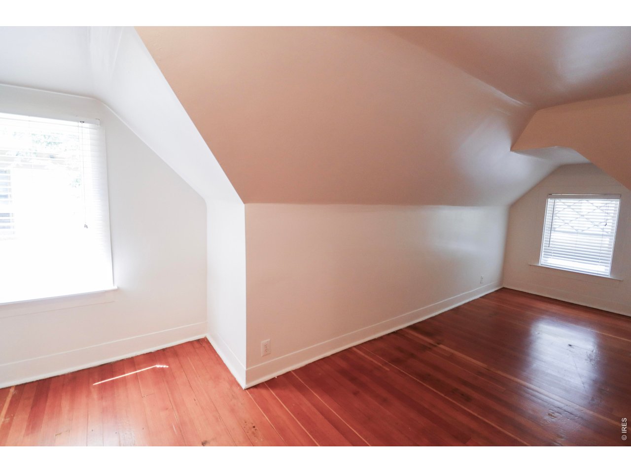 608 South Howes Street Fort Collins, CO 80521 - Photo 20 of 28 a view of an empty room with wooden floor and a window
