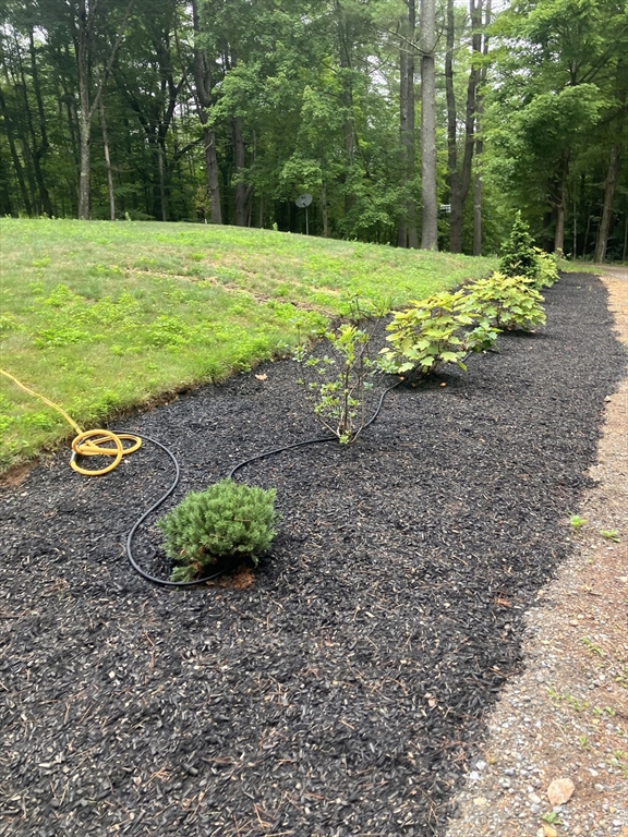 16 Wheeler Road Princeton, MA 01541 - Photo 39 of 40 a view of a garden with a fountain