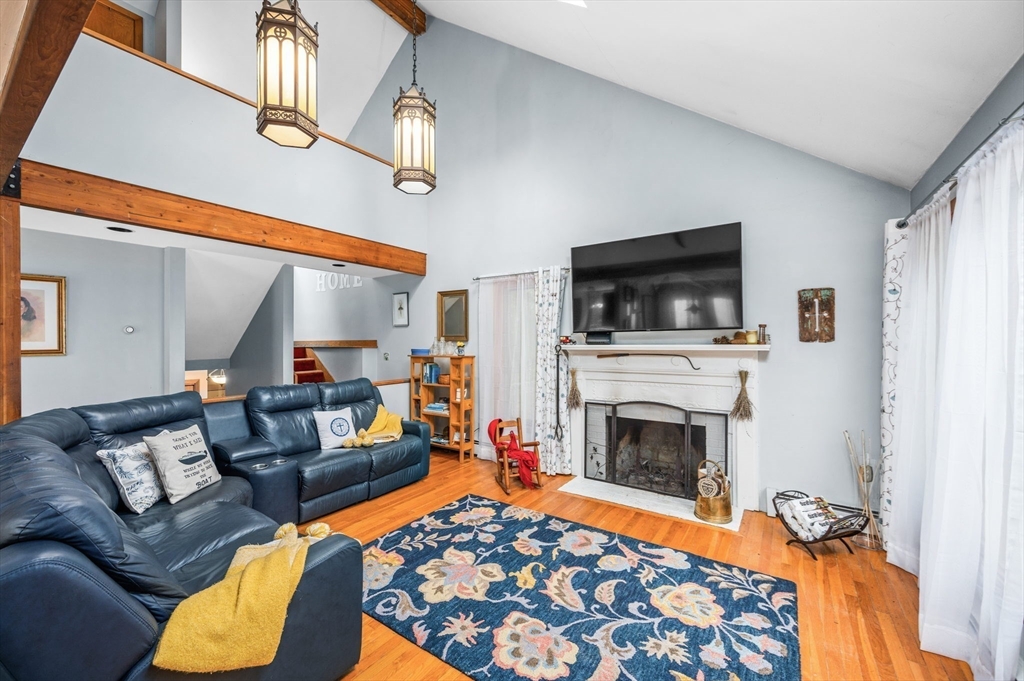 16 Wheeler Road Princeton, MA 01541 - Photo 8 of 40 a living room with furniture a flat screen tv and a fireplace