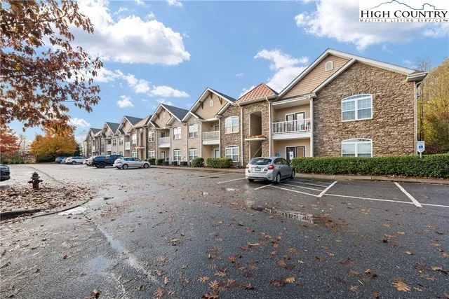 a view of road with card parked on the roadside