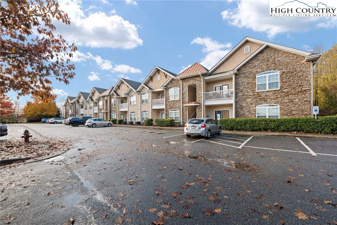 a view of road with card parked on the roadside