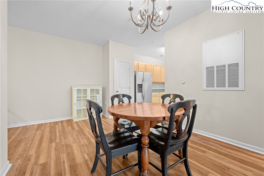 247 Eli Hartley Drive, Unit 111 Boone, NC 28607 - Photo 11 of 28 a view of a dining room with furniture and wooden floor