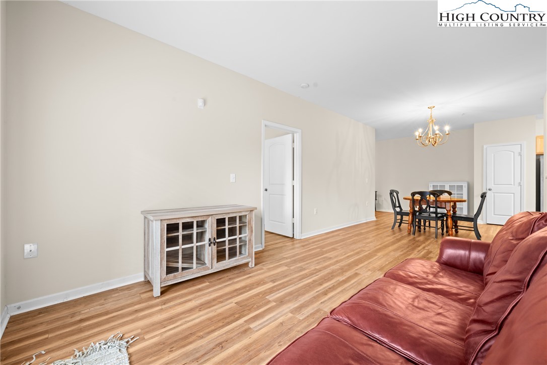 247 Eli Hartley Drive, Unit 111 Boone, NC 28607 - Photo 13 of 28 a view of a livingroom with furniture and wooden floor