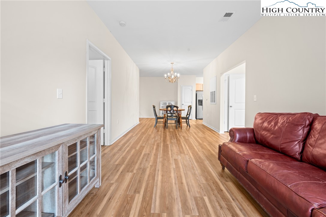 247 Eli Hartley Drive, Unit 111 Boone, NC 28607 - Photo 15 of 28 a living room with furniture and a wooden floor