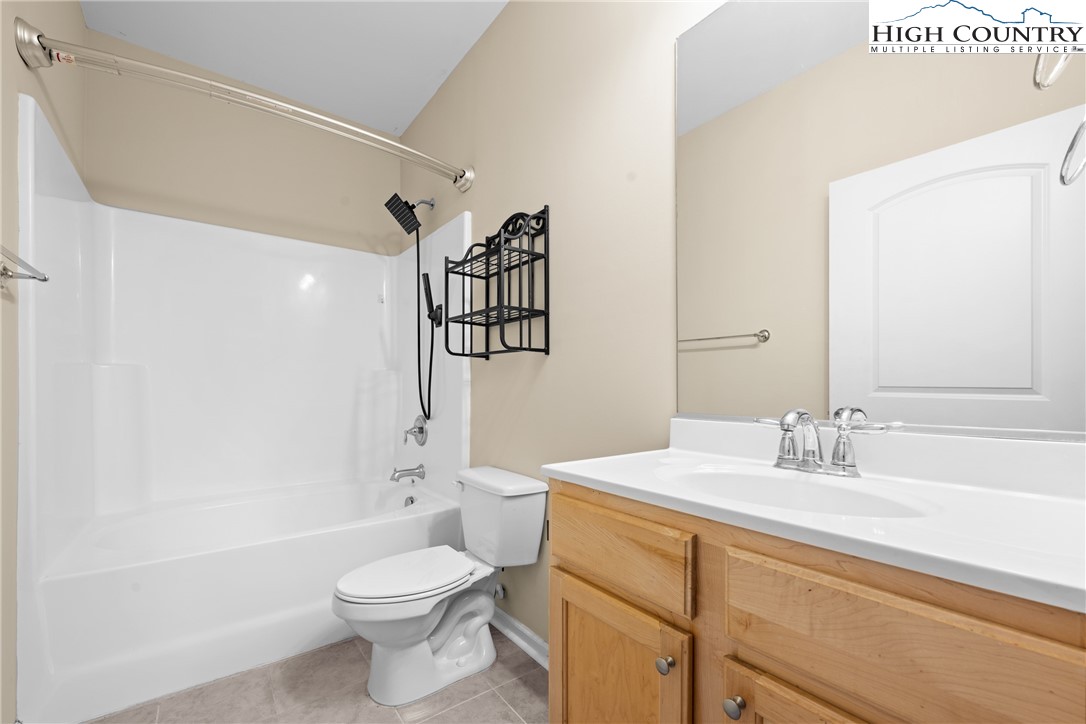 247 Eli Hartley Drive, Unit 111 Boone, NC 28607 - Photo 19 of 28 a bathroom with a sink a toilet and shower