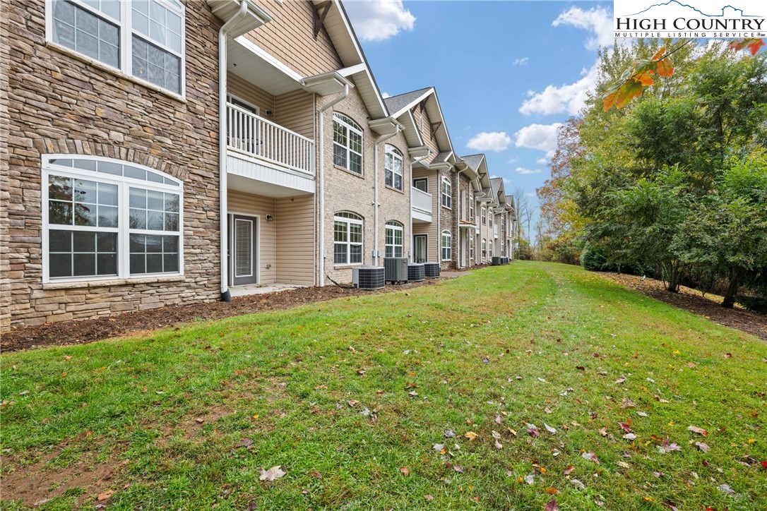 247 Eli Hartley Drive, Unit 111 Boone, NC 28607 - Photo 2 of 28 a view of a house with a yard and sitting area