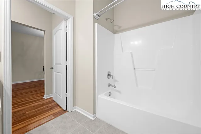 a bathroom with a bathtub and shower