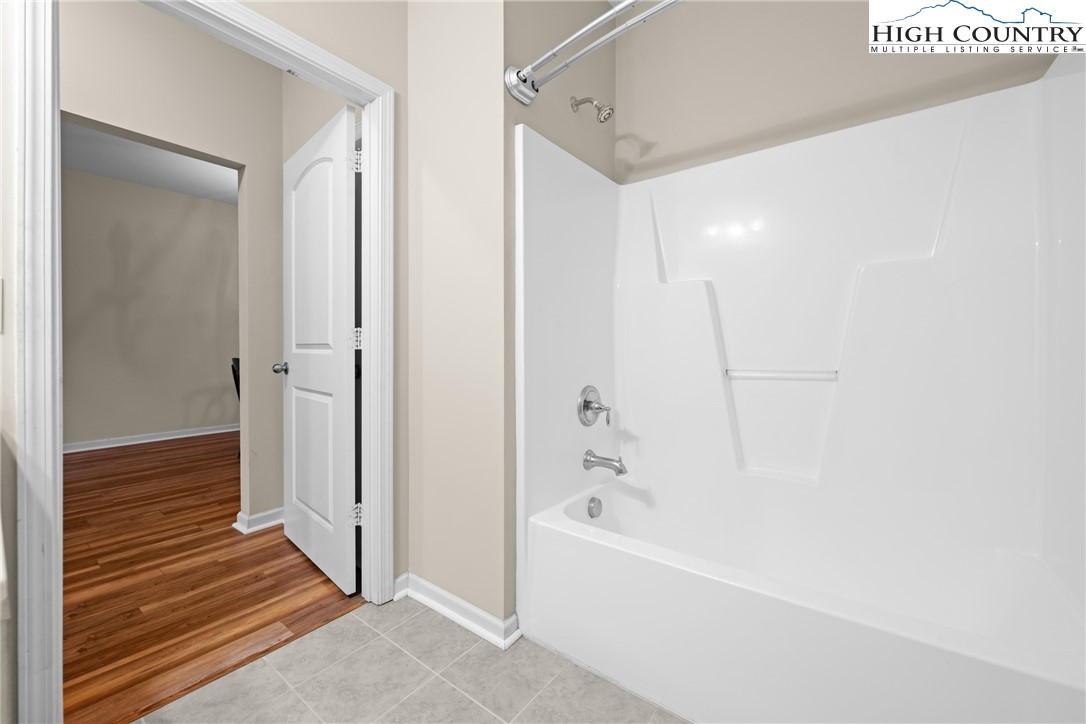 247 Eli Hartley Drive, Unit 111 Boone, NC 28607 - Photo 22 of 28 a bathroom with a bathtub and shower