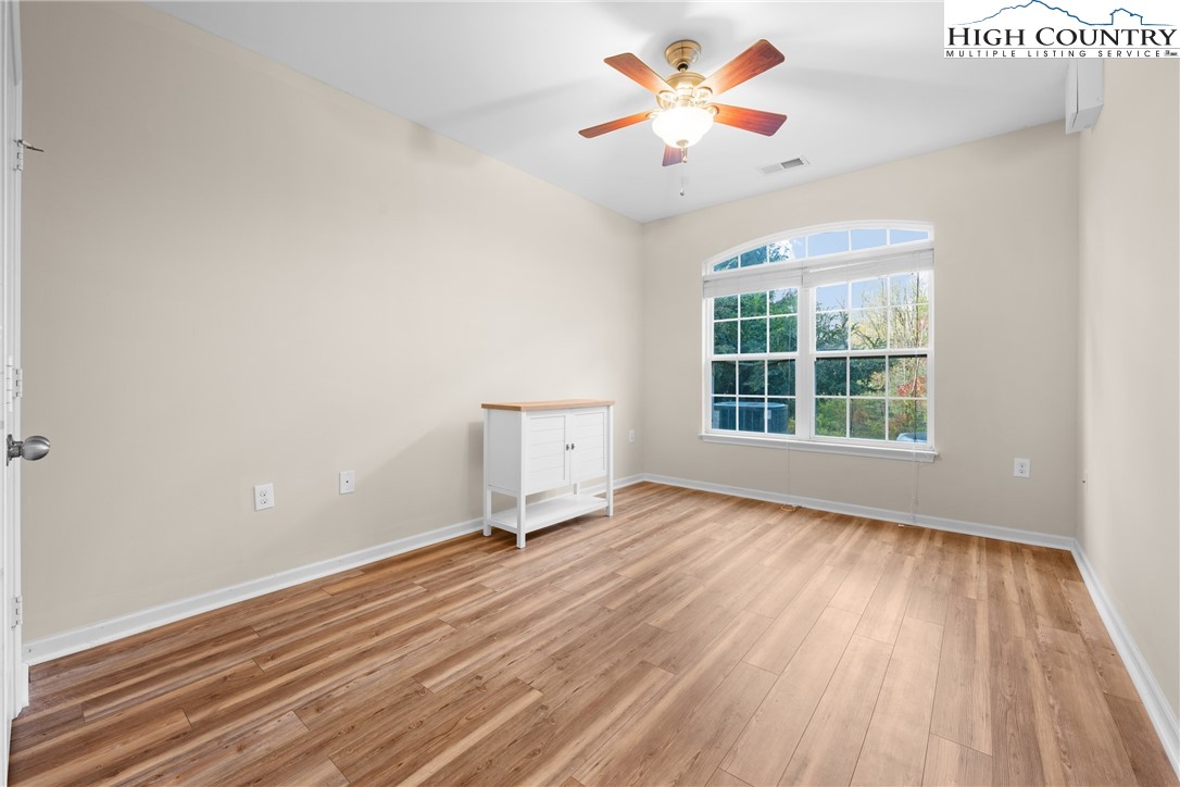 247 Eli Hartley Drive, Unit 111 Boone, NC 28607 - Photo 24 of 28 wooden floor in an empty room with a window