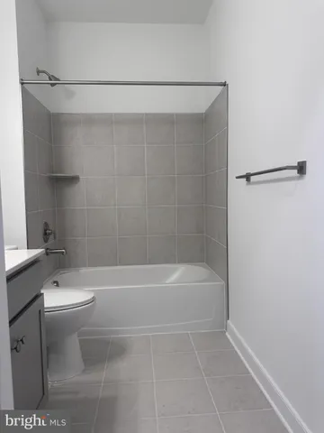 a bathroom with a bathtub a toilet and a shower