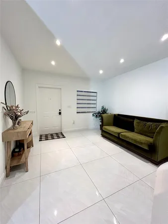 a living room with furniture a air conditioner and a window