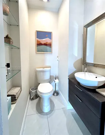 a bathroom with a toilet sink and mirror