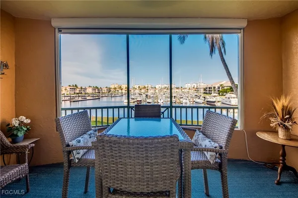 a view of a balcony with chairs and a potted plant