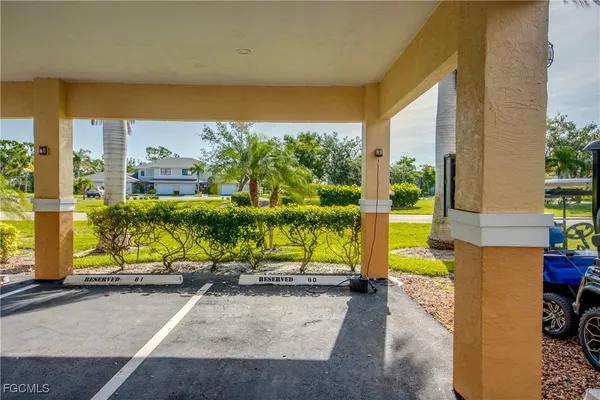 a view of a patio with plants and table and chairs under an umbrella with potted plants
