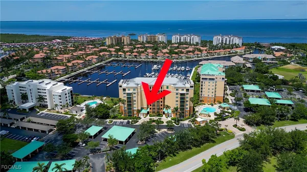 an aerial view of multiple houses with a yard
