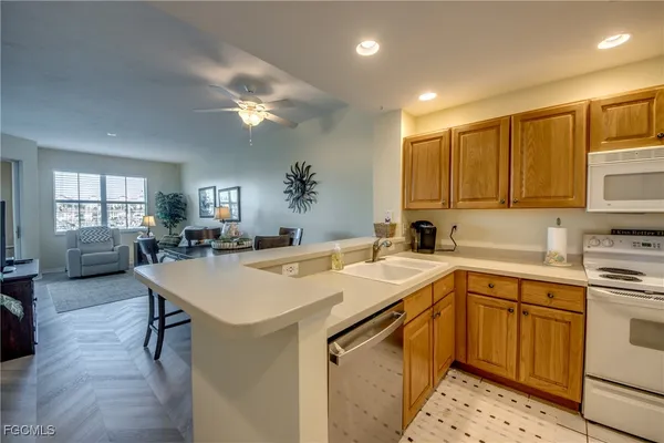 a kitchen with a sink appliances and cabinets