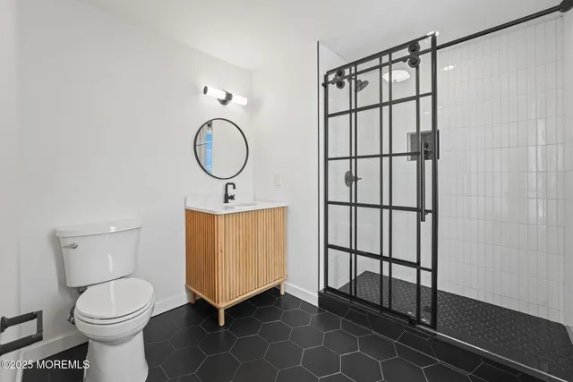 a bathroom with a toilet sink and mirror