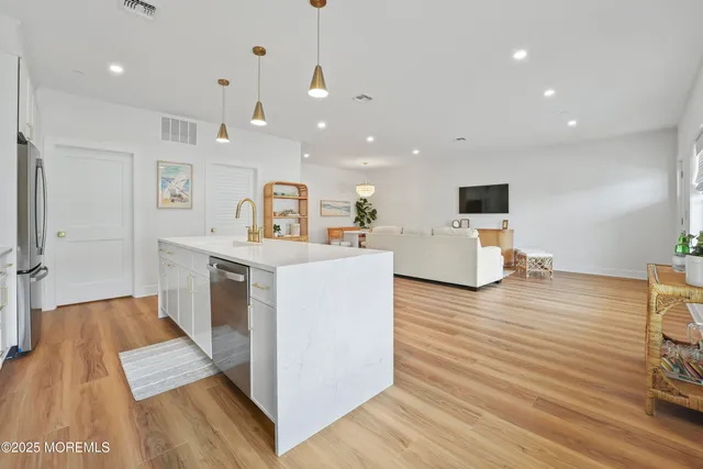 a view of kitchen with cabinets and wooden floor