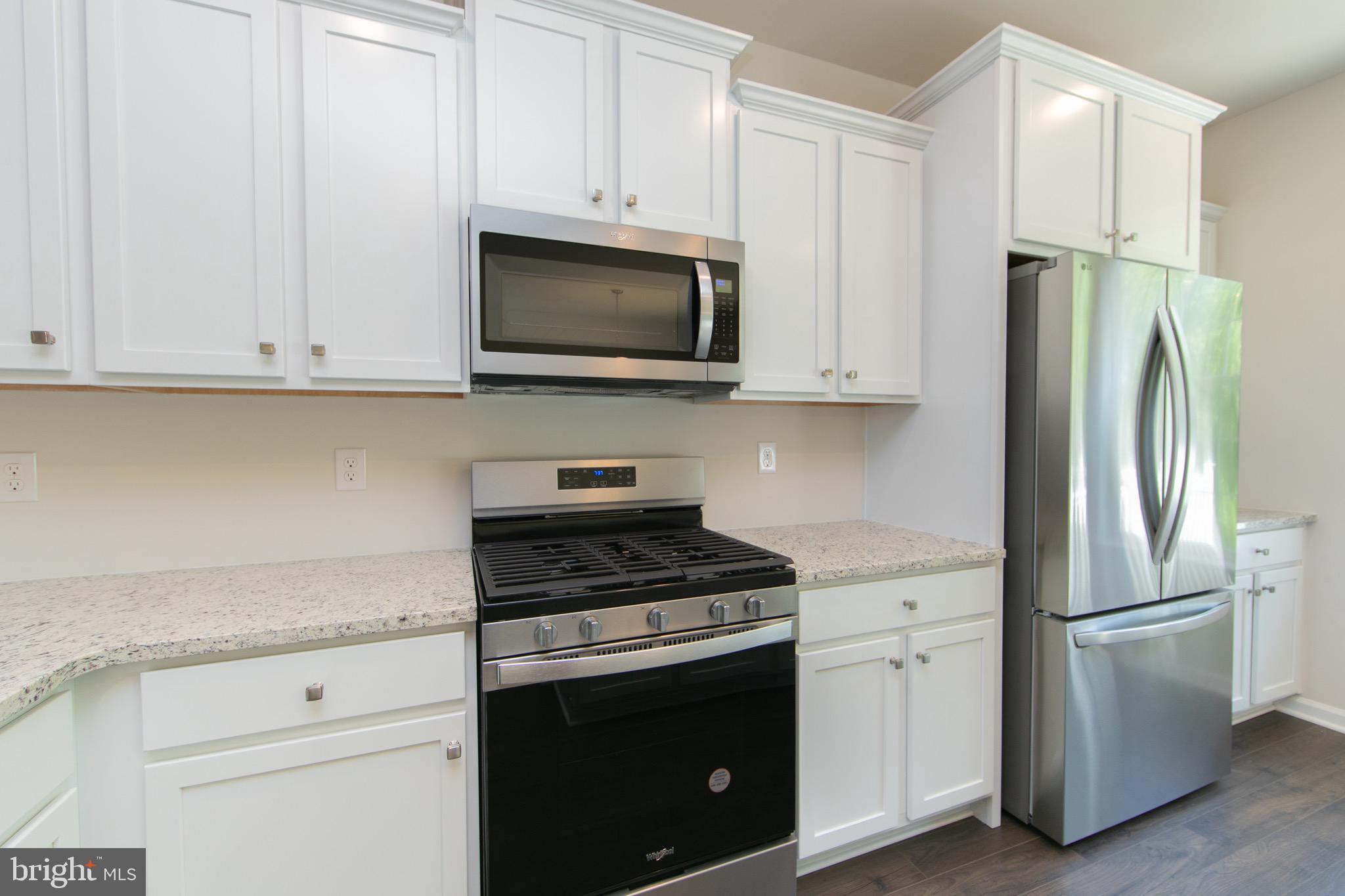 495 Monte Farm Road Mount Laurel, NJ 08054 - Photo 11 of 34 a kitchen with stainless steel appliances granite countertop white cabinets a refrigerator and a stove top oven