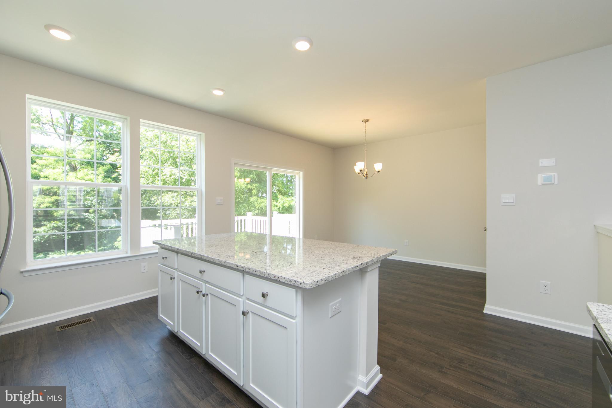 495 Monte Farm Road Mount Laurel, NJ 08054 - Photo 12 of 34 a kitchen with stainless steel appliances granite countertop a sink a window and wooden floor