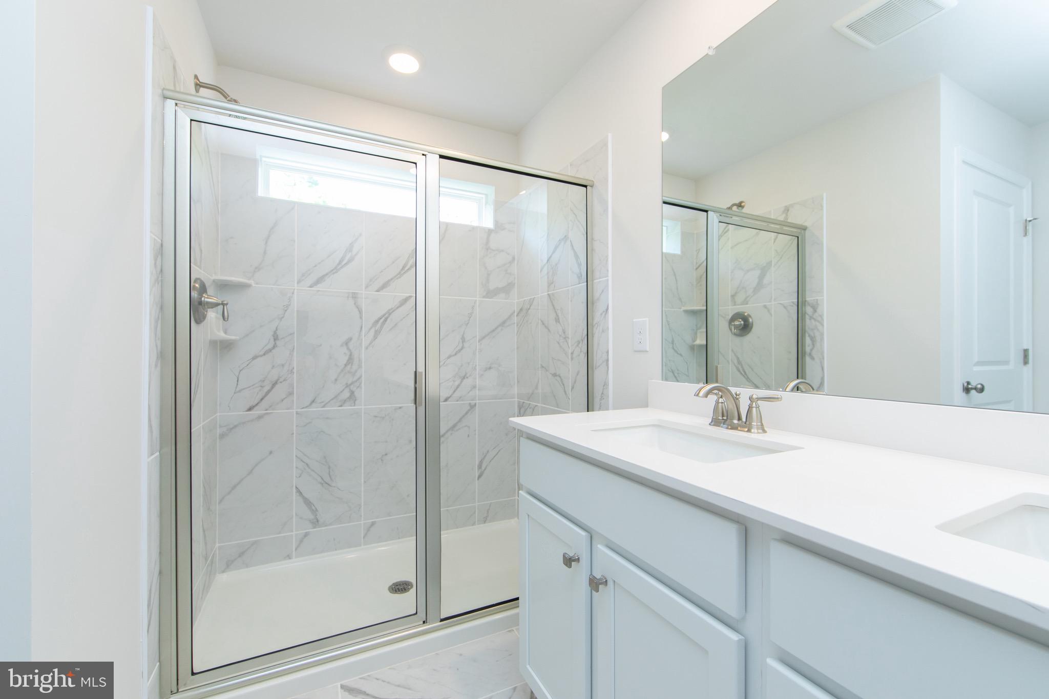 495 Monte Farm Road Mount Laurel, NJ 08054 - Photo 20 of 34 a bathroom with a shower sink and mirror