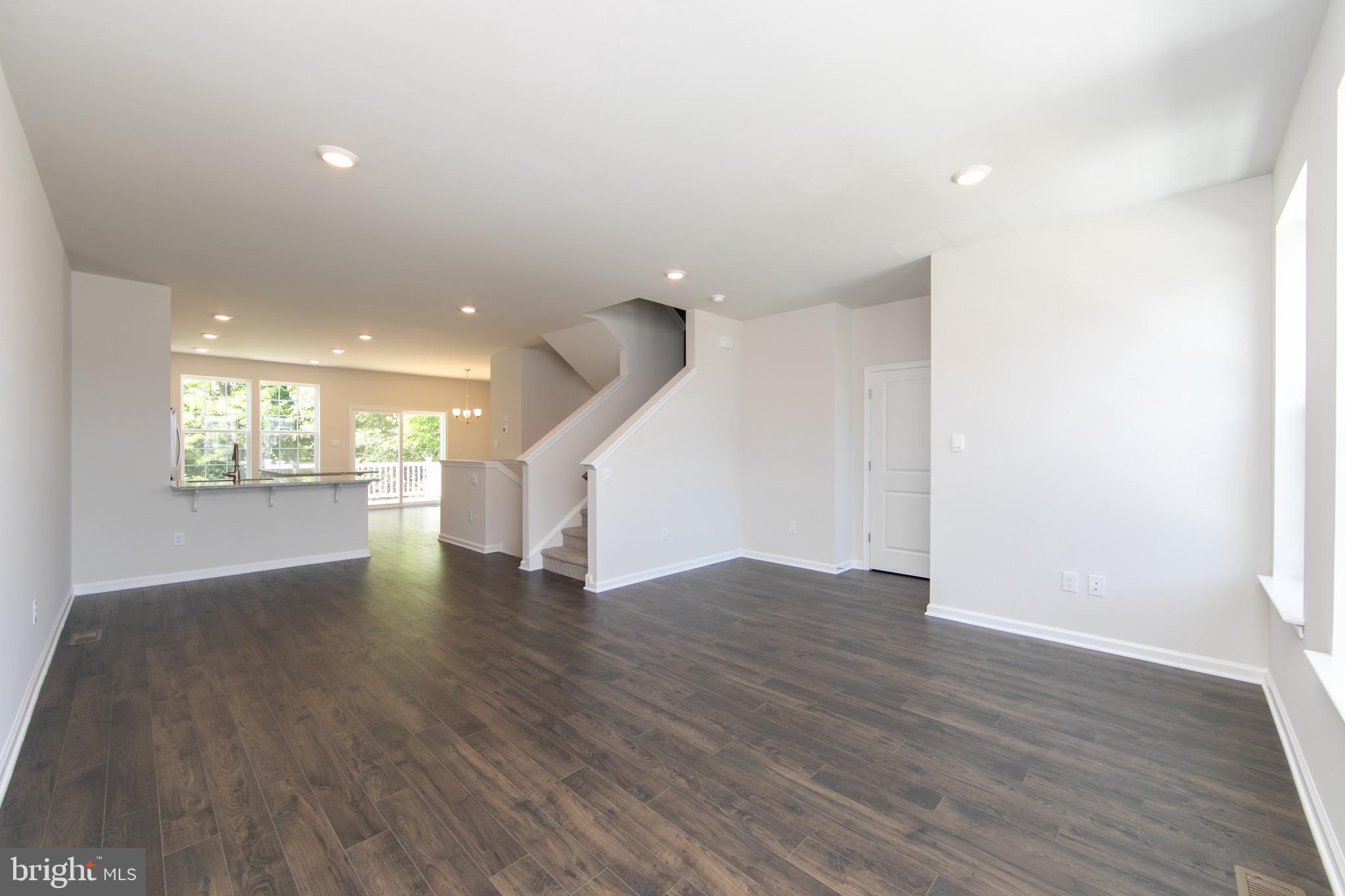 495 Monte Farm Road Mount Laurel, NJ 08054 - Photo 5 of 34 a view of an empty room with wooden floor kitchen view and a window
