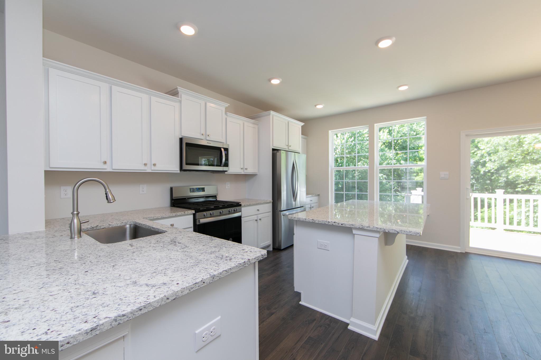 495 Monte Farm Road Mount Laurel, NJ 08054 - Photo 7 of 34 a kitchen with granite countertop stainless steel appliances a stove sink microwave and refrigerator