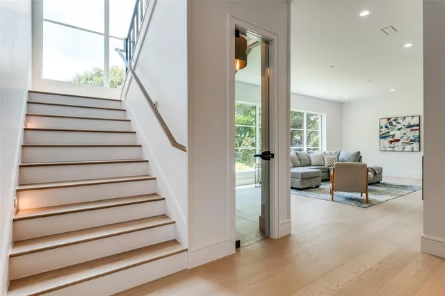 a view of entryway and hall with wooden floor