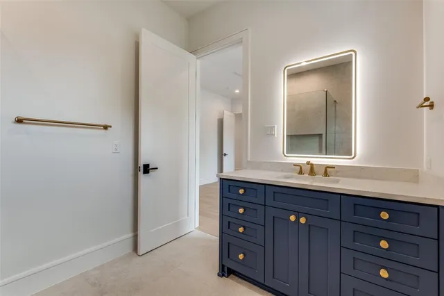 a bathroom with a double vanity sink and mirror with shower