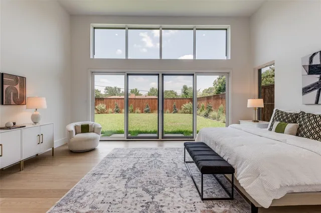 a bedroom with a bed and large window