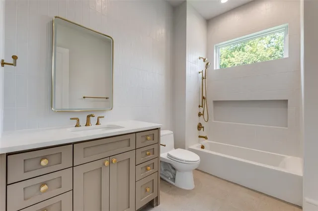 a bathroom with double sink and a mirror