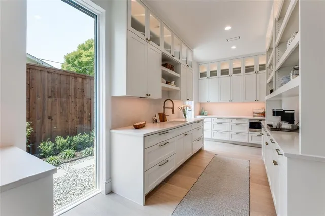 a kitchen with stainless steel appliances kitchen island granite countertop a sink stove and cabinets