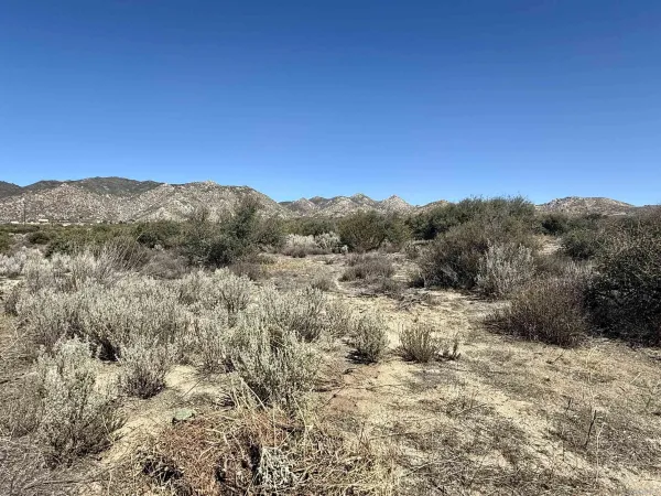 a view of a city with mountains in the background