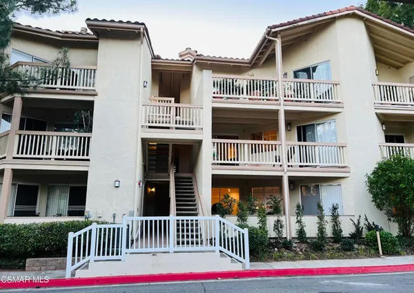 a front view of a house with entryway and a yard