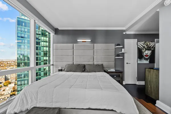 a bedroom with a large bed and a large window