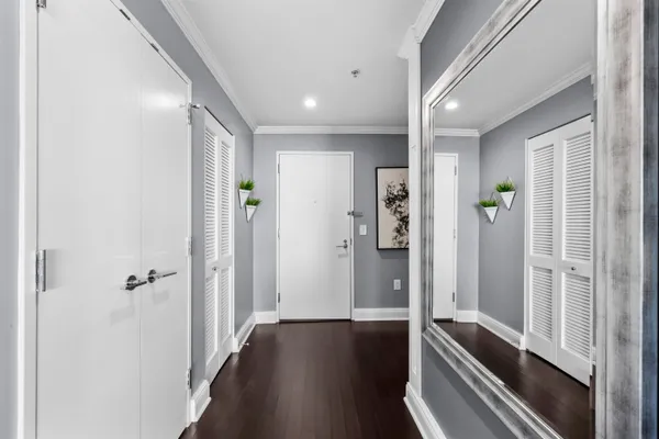 a view of a hallway with wooden floor and staircase