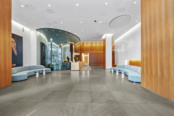 a lobby with furniture and a large window