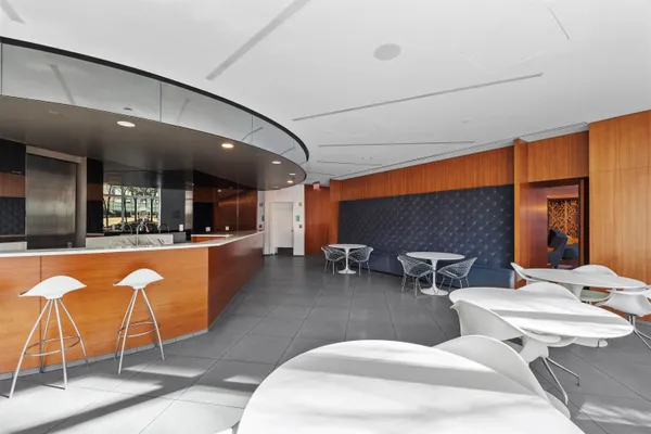 a lobby with furniture and kitchen view