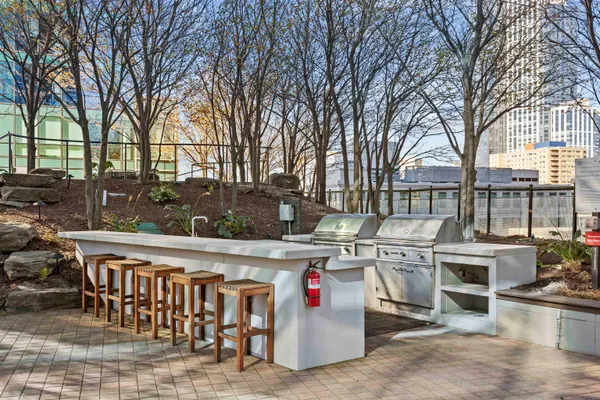a view of outdoor kitchen with stainless steel appliances