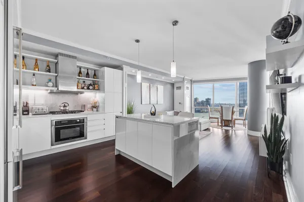 a kitchen with counter top space and wooden floor